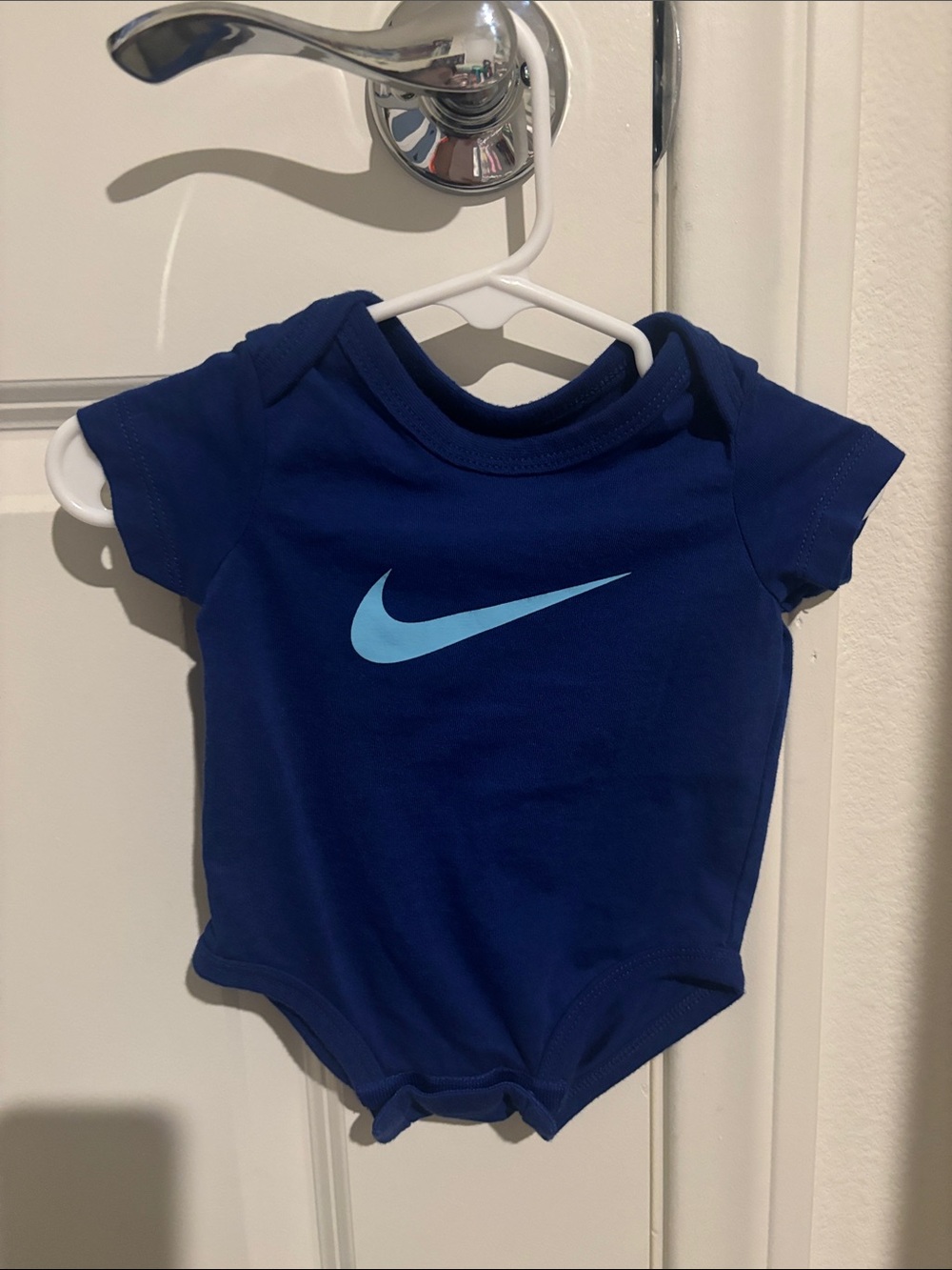 Nike Baby One-Piece Bodysuit in Navy with Light Blue Swoosh